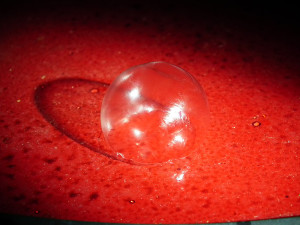 Flashlight on Frozen Bubble w Red Table by Sue Henderson