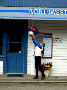 Evelyn stretches to hang the flowers at the Visitors Center