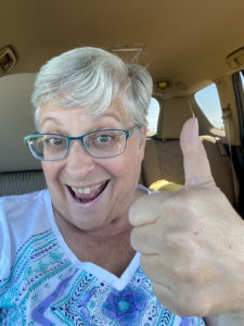 woman with excited thumbs up