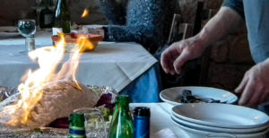 Salt-crusted flaming fish served tableside