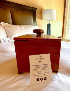 Luxury bedding and a wooden shoe box