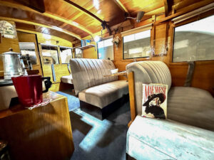 interior of a 1931 mobile trailer for Mae West with padded banquet seating and oak woodwork