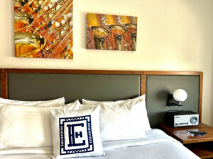 hotel room in Elkhart, Indiana, modern plush bedding and musical instruments in the artwork above the headboard