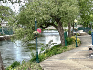 Pathway along a river in Elkhart, Indiana with trees in spring bloom